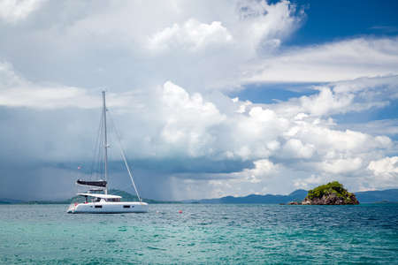 Beautiful seascape with azure water of the Adaman Sea with a yacht and blue sky with clouds....