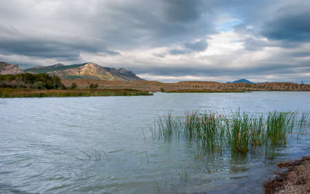 Beautiful Crimean landscape. Lake and mountains in the background with a beautiful evening sky.の写真素材