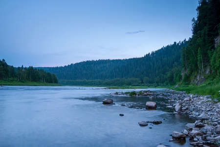 Landscapes of Siberia. Evening landscape at sunset. Mountains, forest, river and water at long exposure. Kemerovo region. Russiaの写真素材