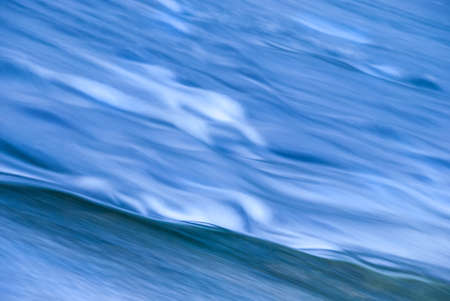 Mountain River. Stones and blue water on a long shutter speed.の写真素材