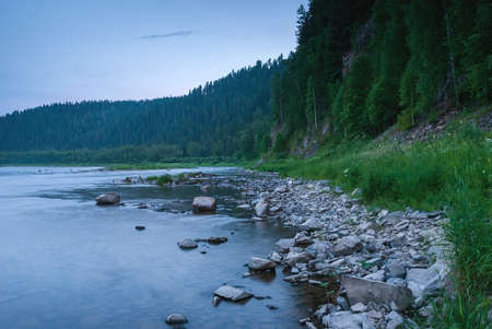 Landscapes of Siberia. Evening landscape at sunset. Mountains, forest, river and water at long exposure. Kemerovo region. Russiaの写真素材