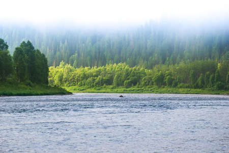 Landscapes of Siberia. Early morning on the Kiya river. Fog descends on the river over the taiga. Kemerovo region.の写真素材