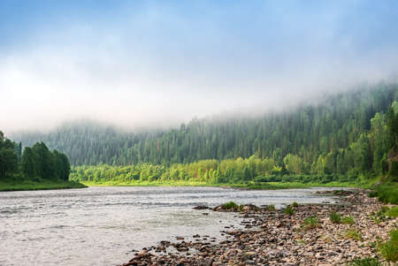Landscapes of Siberia. Early morning on the Kiya river. Fog descends on the river over the taiga. Kemerovo region.の写真素材