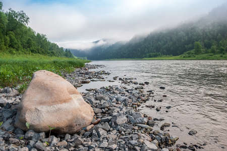 Landscapes of Siberia. Early morning on the Kiya river. Fog descends on the river over the taiga. Kemerovo region.の写真素材