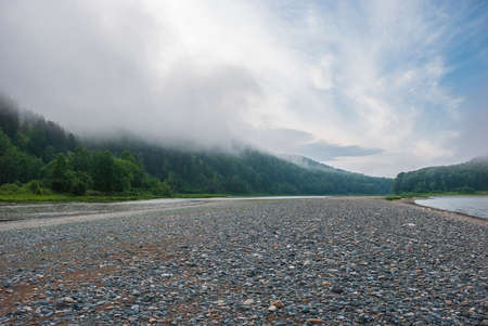 Landscapes of Siberia. Early morning on the Kiya river. Fog descends on the river over the taiga. Kemerovo region.の写真素材