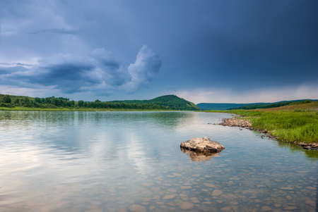 Landscapes of Siberia. Evening landscape on the Kiya river. Mountains, forest, river and water at long exposure. Kemerovo region. Russiaの写真素材