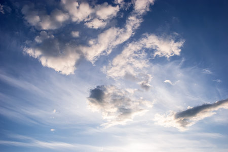 Blue sky with beautiful white heap clouds at sunset.の写真素材