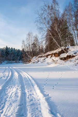 Winter landscape at sunset. The riverbed, spruce and birch trees are a truly Russian landscape.の写真素材