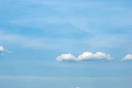 Blue sky background with tiny clouds.