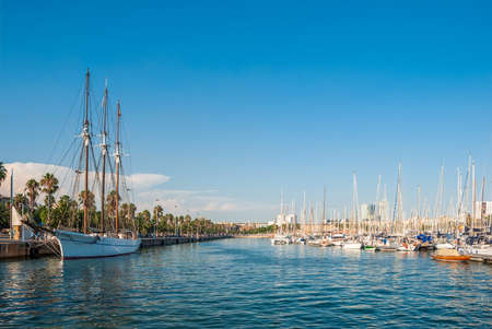 Royal Yacht Club of Barcelona. Yachts against the backdrop of blue clear skies and azure waters of the sea.の写真素材