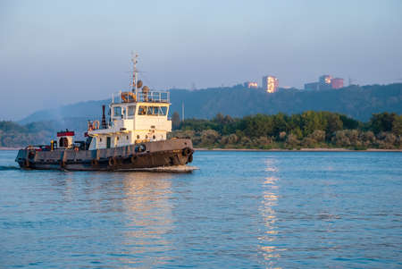 A barge sailing along the Volga River at sunset.の写真素材