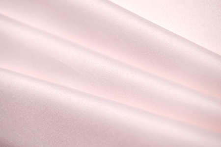 Background, texture. Template. Satin cloth for wedding and evening dresses. A nude shade.の写真素材