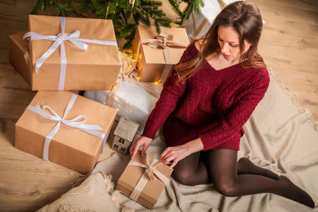 Merry Christmas and Happy Holidays! A young beautiful girl on New Year's Eve with boxes of gifts.の写真素材