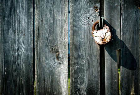 A padlock on a shabby old door.の写真素材
