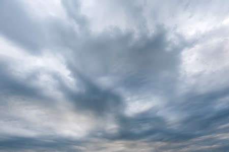 Stormy skies with dramatic clouds from approaching thunderstorms at sunsetの写真素材