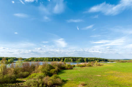 Bright summer landscape with beautiful lake and blue sky with clouds.の写真素材