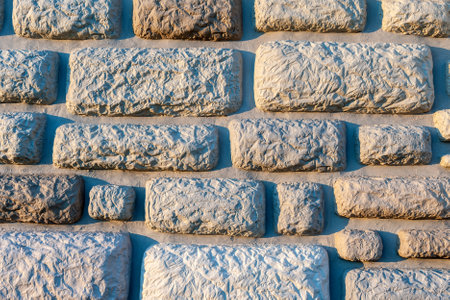 Stone textured walls in the evening sun.の写真素材