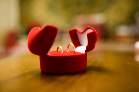 Wedding rings in a red velvet jewelry boxの写真素材
