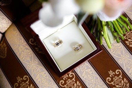Wedding rings in a brown wooden jewelry box