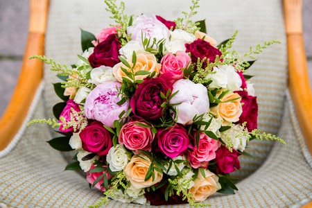 Buds of roses and peonies in a luxurious wedding bouquet on the chair, top viewの写真素材