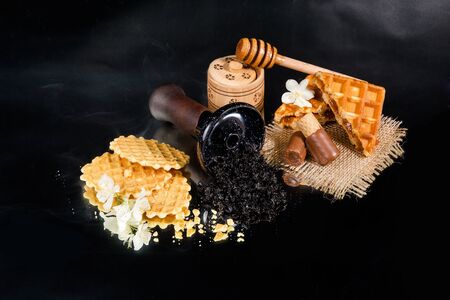 Hookah bowl with tobacco and Belgian waffles. Cake shisha tobacco.の写真素材