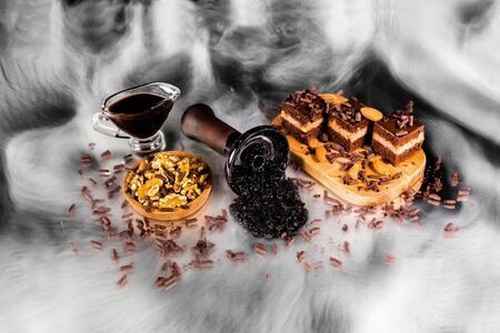 Hookah bowl with tobacco in the smoke and chocolate pie. Chocolate with nuts shisha tobacco.の写真素材