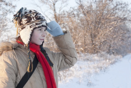 Teen girl looking far away at snowy winter day