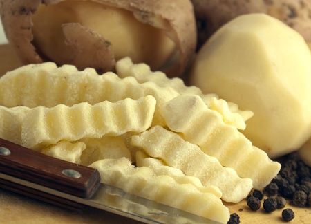 Raw potatoes with knifeの写真素材