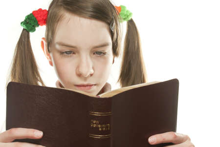 Teen girl reading the Bible isolated on whiteの写真素材