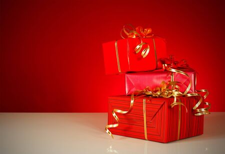 Christmas gifts over red backgroundの写真素材
