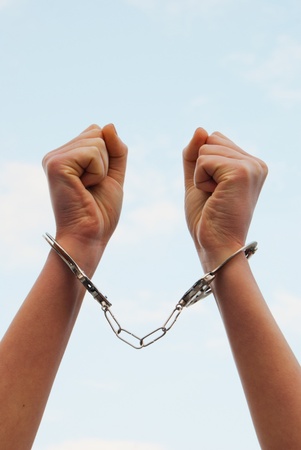 Handcuffed woman hands