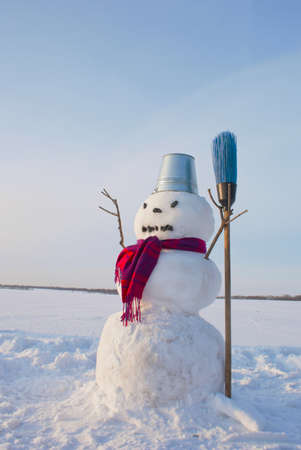 Lonely snowman at a snowy field at winter timeの写真素材