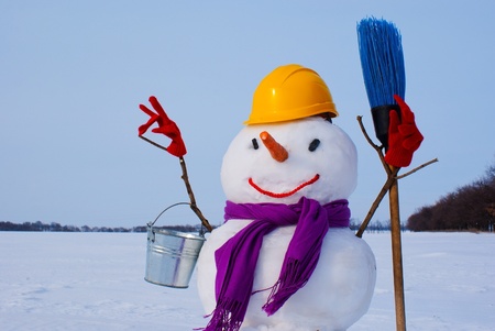Lonely snowman at a snowy field at winter timeの写真素材