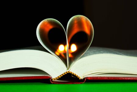 Open book laying on the table with heart shaped pagesの写真素材