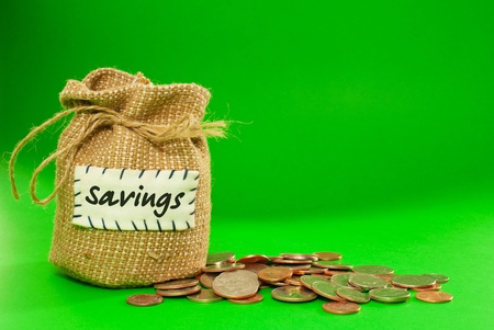 Sack full of coins over green backgroundの写真素材