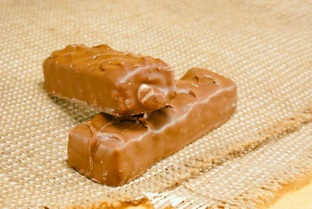 Two chocolate bars laying on burlap 