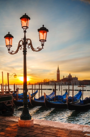 Gondolas floating in the Grand Canal on a cloudy dayの写真素材