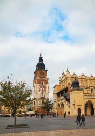KRAKOW, POLAND - OCTOBER 11: Town hall tower at old market square with tourists on October 11, 2012 in Krakow. The square is a principal urban space located at the center of the city and â at roughly 40,000 sq. m â it is the largest medieval town squaのeditorial素材