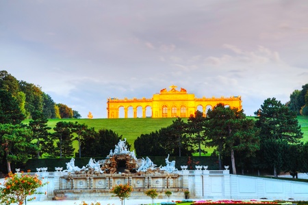 VIENNA - OCTOBER 06: Gloriette Schonbrunn at sunset with tourists on October 06, 2012 in Vienna. It's the largest and most well-known gloriette in Vienna built in 1775 in the garden according to the plans of architect Johann Hetzendorf.のeditorial素材