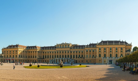 VIENNA - OCTOBER 06: Schonbrunn palace at sunset with tourists on October 06, 2012 in Vienna. It's a former imperial 1,441-room Rococo summer residence and one of the most important cultural monuments in the country.のeditorial素材