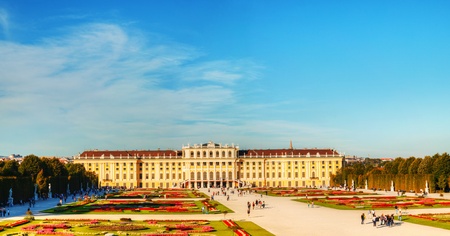 VIENNA - OCTOBER 06: Schonbrunn palace at sunset with tourists on October 06, 2012 in Vienna. It's a former imperial 1,441-room Rococo summer residence and one of the most important cultural monuments in the country.のeditorial素材