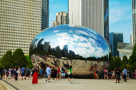 CHICAGO - MAY 18: Cloud Gate sculpture in Millenium park with tourists on May 18, 2013 in Chicago, IL. It's a public sculpture by Indian-born British artist Anish Kapoor, is the centerpiece of the AT&T Plaza in Millennium Park within the Loop community arのeditorial素材