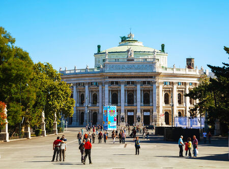 VIENNA - OCTOBER 06: The Burgtheater with tourists on October 06, 2012 in Vienna, Austria. It's the Austrian National Theatre in Vienna and one of the most important German language theatres in the world.のeditorial素材