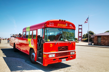 SAN FRANCISCO - APRIL 23: Sightseeing tour bus at the Golden Gate bridge on April 23, 2014 in San Francisco, California. It's the cultural center and a leading financial hub of the San Francisco Bay Area and Northern California.のeditorial素材