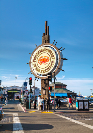 SAN FRANCISCO - APRIL 24: Famous Fisherman's Wharf sign with tourists on April 24, 2014 in San Francisco, California. It's one of the busiest and well known tourist attractions in the western United States.のeditorial素材