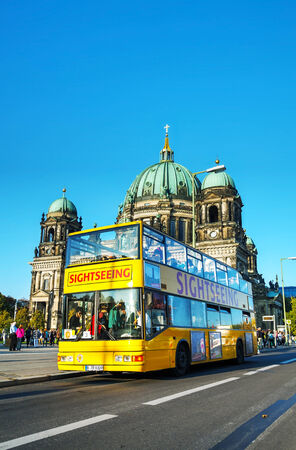 BERLIN - OCTOBER 3, 2014: Touristic bus at Berliner Dom on October 3, 2014 in Berlin, Germany. Berliner Dom is the short name for the Evangelical Supreme Parish and Collegiate Church. It is located on Museum Island in the Mitte borough.のeditorial素材