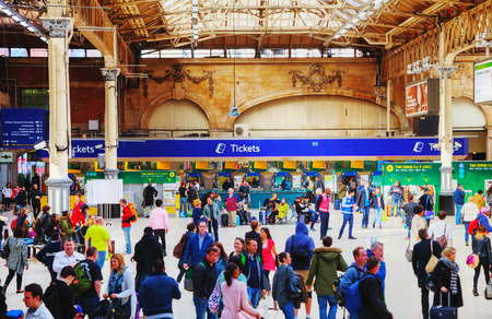LONDON - APRIL 12: People at the Victoria station on April 12, 2015 in London, UK. Station, generally known as Victoria, is a central London railway terminus and London Underground complex named after Victoria Street.のeditorial素材