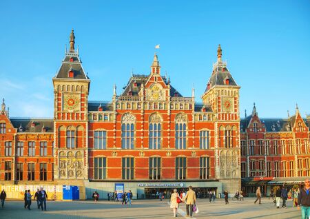 AMSTERDAM - APRIL 15: Amsterdam Centraal railway station on April 15, 2015 in Amsterdam, Netherlands. Amsterdam Centraal is the largest railway station of Amsterdam, and a major national railway hub.のeditorial素材