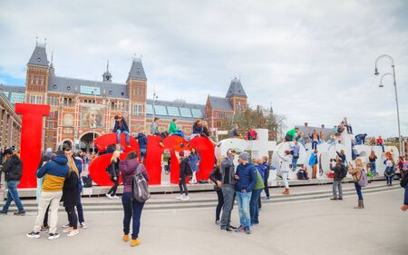 AMSTERDAM - APRIL 16: I Amsterdam slogan with crowd of tourists on April 16, 2015 in Amsterdam. Located at the back of the Rijksmuseum on Museumplein, the slogan quickly became a city icon.のeditorial素材