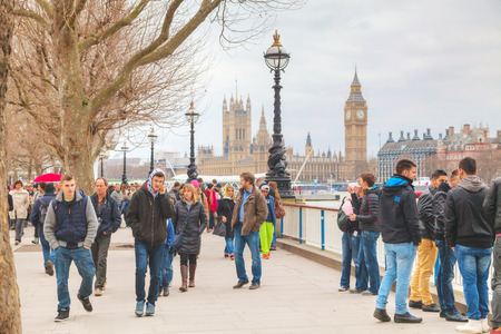 LONDON - APRIL 4: Thames riverbank crowded with tourists on April 4, 2015 in London, UK. London is a popular centre for tourism, one of its prime industries, employing the equivalent of 350,000 full-time workers.のeditorial素材